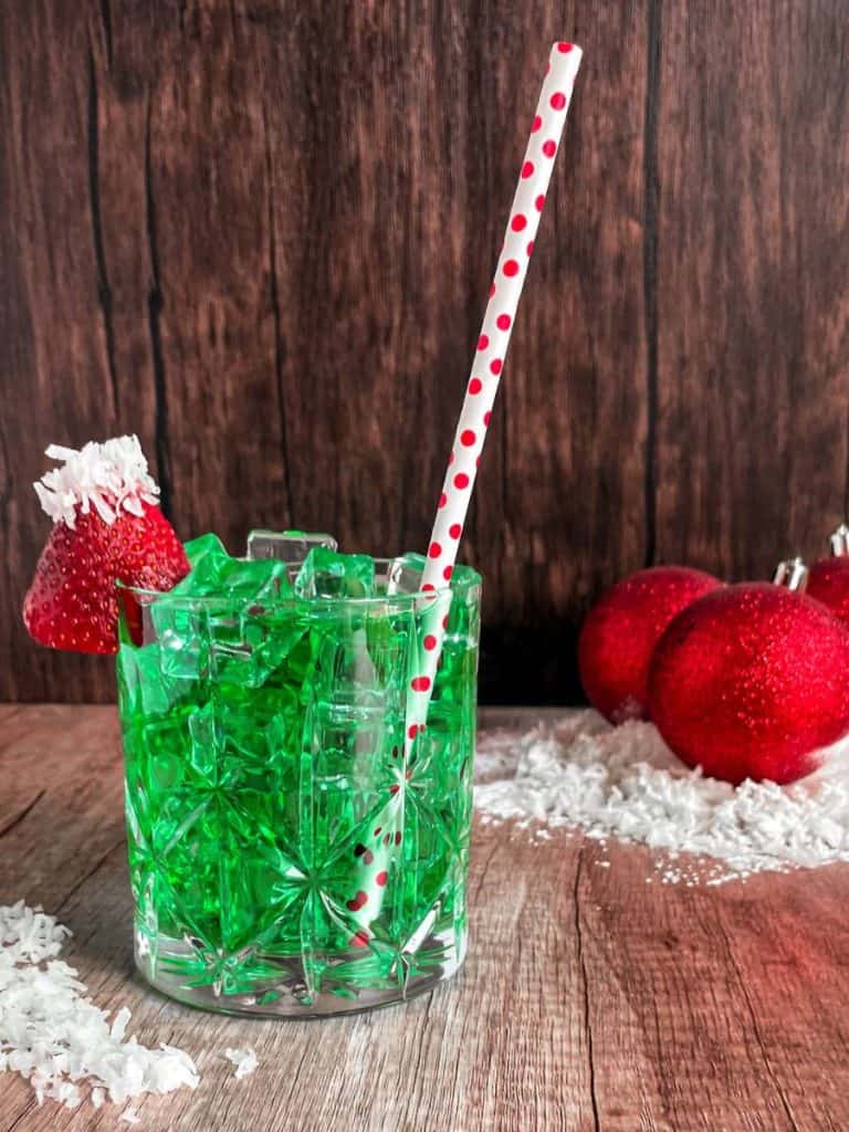 green Christmas drink with Santa hat garnish