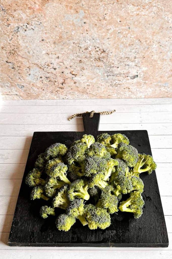 broccoli on black cutting board