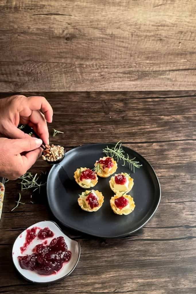 cranberry brie bites with pecans on top