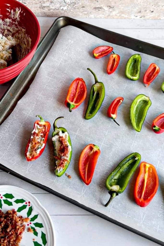 mini Stuffed peppers on baking sheet, 2 filled with stuffing 