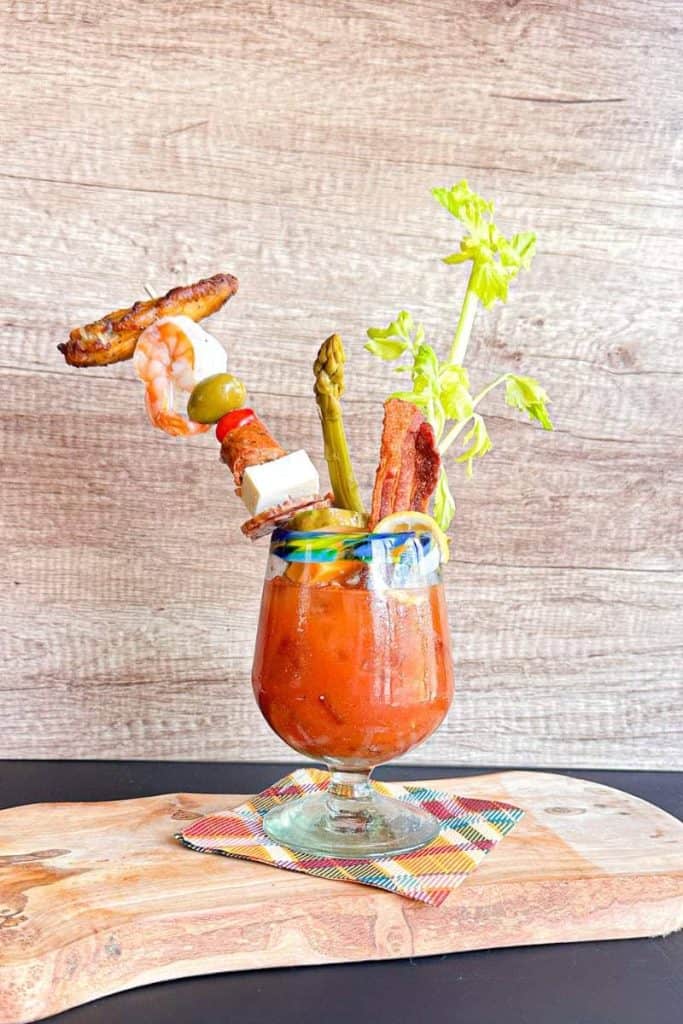 Bloody Mary with chicken wing, shrimp, cheese, olives, bacon, asparagus and celery stalks
