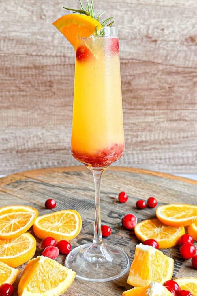cranberry orange mimosa in champagne glass
