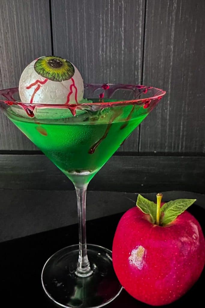 poison apple cocktail with bloody eyeball ice cube