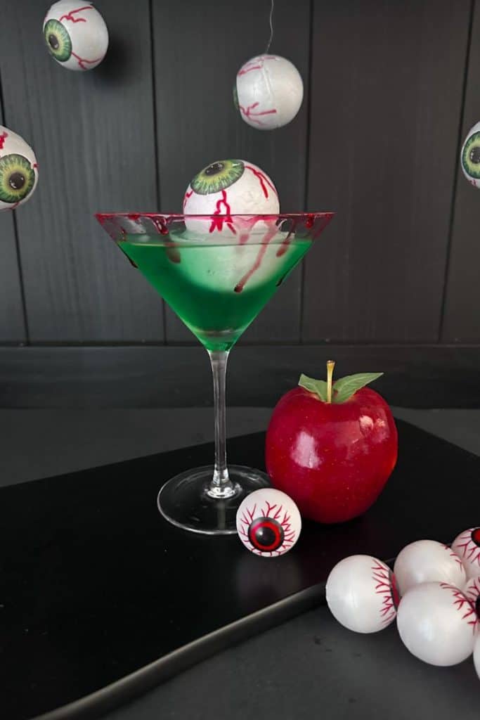 poison apple cocktail with bloody eyeball ice cubes