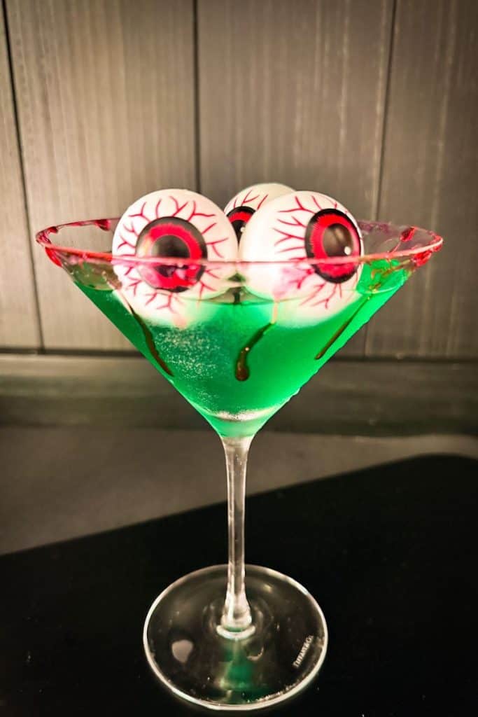 poison apple cocktail with bloody eyeball ice cubes