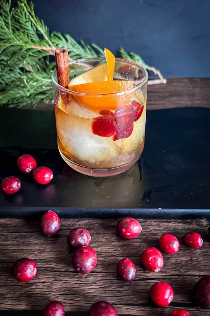 bourbon-infused cranberry Old Fashioned - with cinnamon & orange peel garnish
