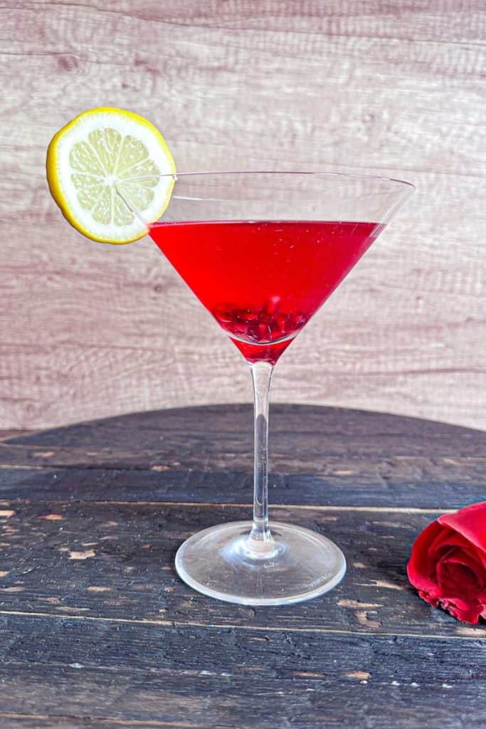 Pomegranate Martini with lemon garnish 