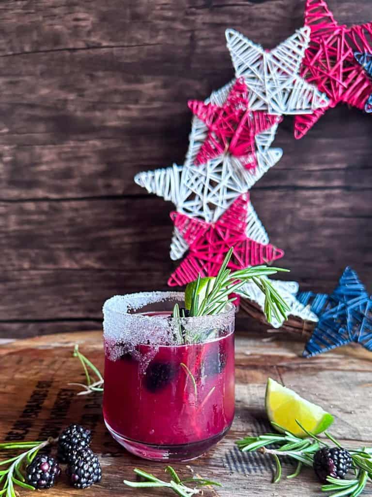 blackberry margarita garnished with salt lime rosemary and blackberries